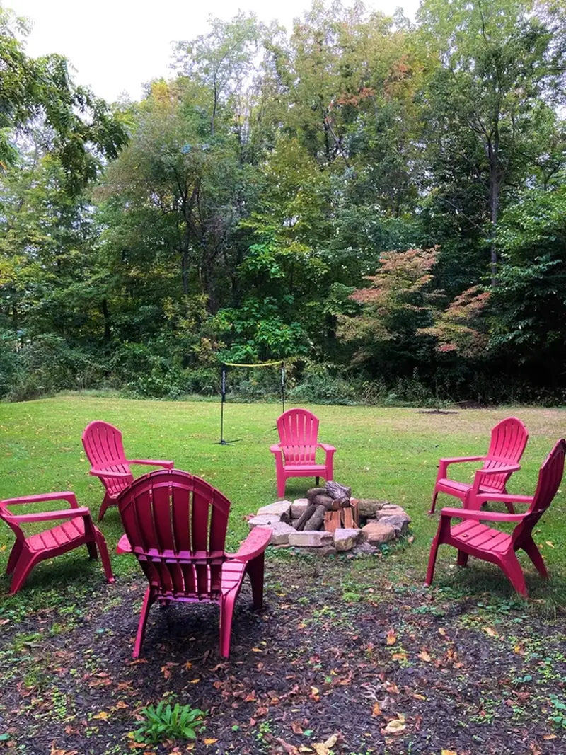 Back yard with fire pit to roast marshmallows from included S'mores Kit, badminton, and horseshoes.